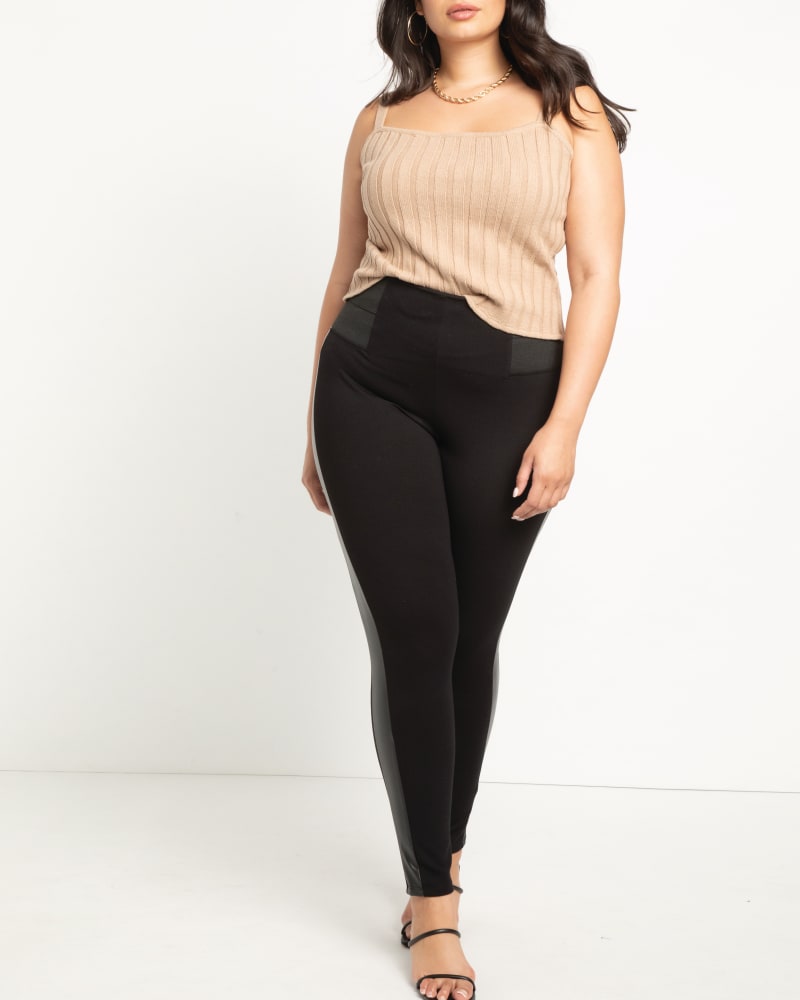 Front of a model wearing a size 14 Miracle Flawless Legging in Totally Black by ELOQUII. | dia_product_style_image_id:206639